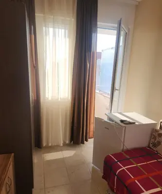 a room with a bed and a window with at Ekilo in Dobra Voda
