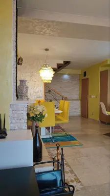 a living room with a dining table and a chandelier at Rezevici AZUR in Budva