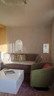 a living room with a couch and a chair at Rezevici AZUR in Budva