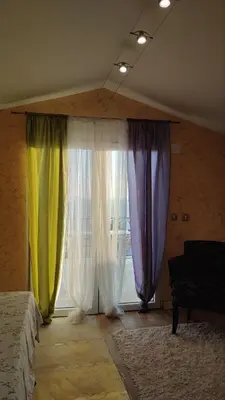 a room with three curtains in front of a window at Rezevici AZUR in Budva