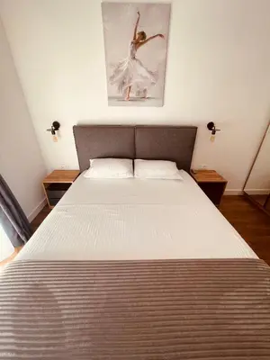 a bedroom with a large bed with a white bedspread at Apartments Buongiorno in Ulcinj