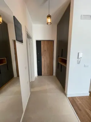 an empty hallway with a wooden door in a building at Apartments Buongiorno in Ulcinj