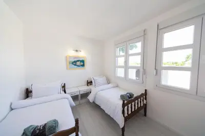 two beds in a room with two windows at Holiday Home Soul