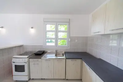 a white kitchen with a sink and a stove at Holiday Home Soul