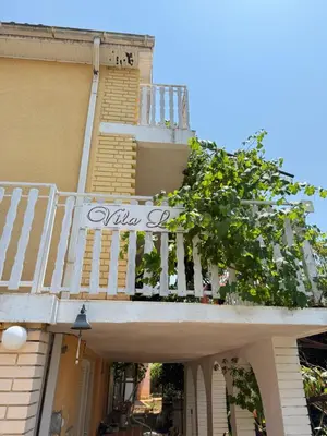 a building with a white railing and a balcony at Dobra Voda Cozy Sea View in Dobra Voda