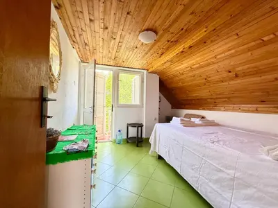 a bedroom with a bed and a wooden ceiling at Dobra Voda Cozy Sea View in Dobra Voda
