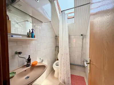 a bathroom with a sink and a toilet at Dobra Voda Cozy Sea View in Dobra Voda
