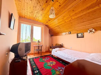 a bedroom with two beds and a flat screen tv at Dobra Voda Cozy Sea View in Dobra Voda