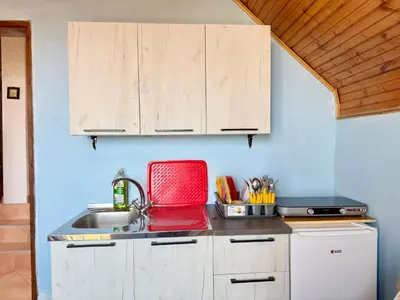 a kitchen with a sink and a red tray at Dobra Voda Cozy Sea View in Dobra Voda