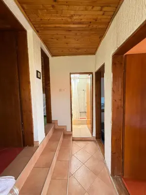 a hallway of a house with a wooden ceiling at Dobra Voda Cozy Sea View in Dobra Voda