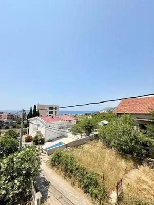 arial view of a city with buildings and the ocean at Dobra Voda Cozy Sea View in Dobra Voda