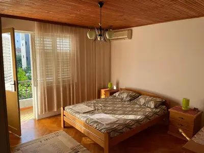 a bedroom with a bed and a large window at Villa Susanj in Bar