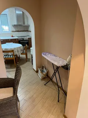 a living room with a table and a kitchen at Villa Susanj in Bar