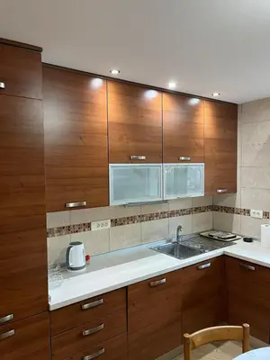 a kitchen with wooden cabinets and a sink at Villa Susanj in Bar
