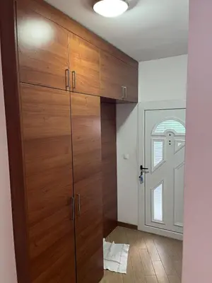 a room with a large wooden cabinet and a door at Villa Susanj in Bar