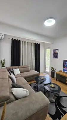 a living room with a couch and two tables at Lux Star in Ulcinj
