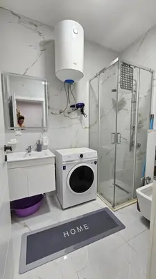 a bathroom with a shower and a sink and a microwave at Lux Star in Ulcinj