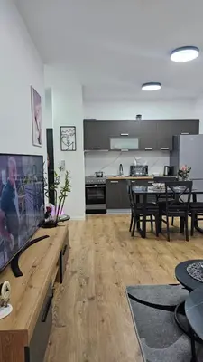 a living room with a kitchen and a dining room at Lux Star in Ulcinj