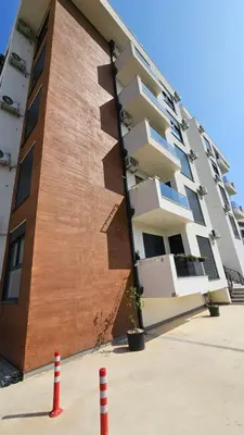 aartment building with a building with orange cones in front of it at Lux Star in Ulcinj