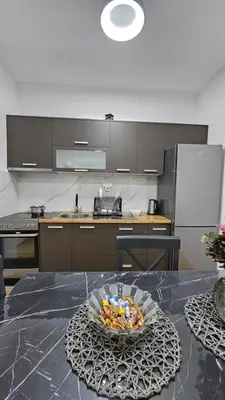 a kitchen with a table with a bowl of food on it at Lux Star in Ulcinj