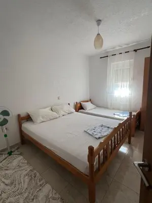 a bedroom with two beds and a window at Haus Binas in Ulcinj