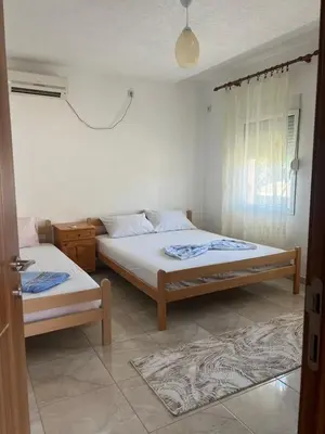 a bedroom with two beds and a window at Haus Binas in Ulcinj