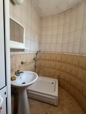 a bathroom with a sink and a bath tub at Haus Binas in Ulcinj