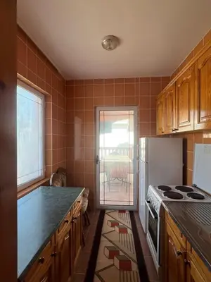 a kitchen with a stove and a refrigerator at Haus Binas in Ulcinj