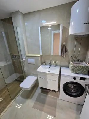 a bathroom with a washing machine and a sink at Apartmani Kralj Bar in Bar