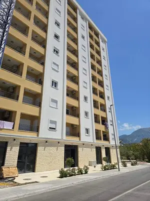 a large apartment building on the side of a street at Apartmani Kralj Bar in Bar