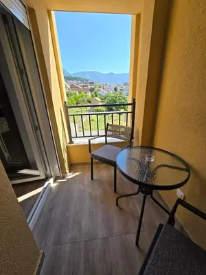 a balcony with a table and chairs and a view at Apartmani Kralj Bar in Bar