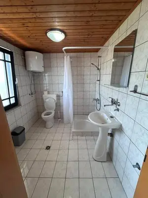 a bathroom with a toilet and a tub and a sink at Apartman MK in Kruče