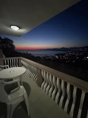 a table and stool on a balcony with a view at Apartman MK in Kruče