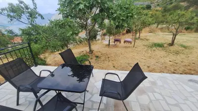 a group of chairs and tables on a patio at Dejana Apartments in Kotor