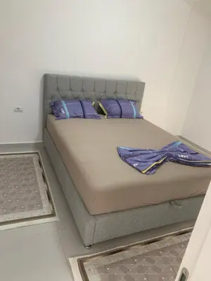 a bed with purple pillows in a room at Flamur Ujkashi in Ulcinj