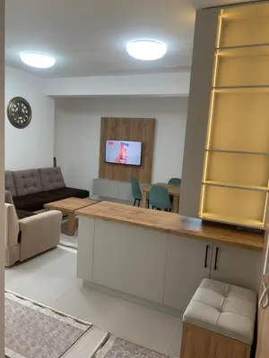 a living room with a couch and a television at Flamur Ujkashi in Ulcinj