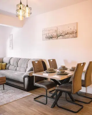 a living room with a table and a couch at Royal Apartment in Ulcinj