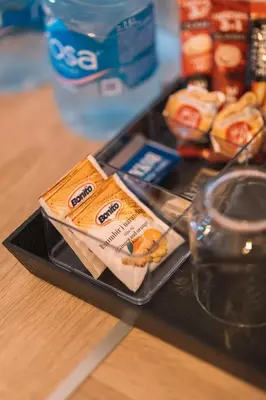 a tray with a box of food on a table at Royal Apartment in Ulcinj