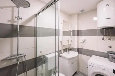 a bathroom with a shower and a toilet and a sink at Royal Apartment in Ulcinj
