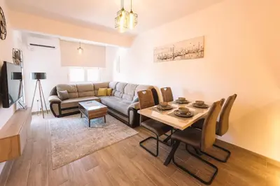 a living room with a couch and a table at Royal Apartment in Ulcinj