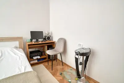 a bedroom with a desk with a computer and a chair at Apartment Seaside in Kotor