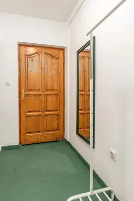 a room with a wooden door and a mirror at Cozy Studio Budva in Budva