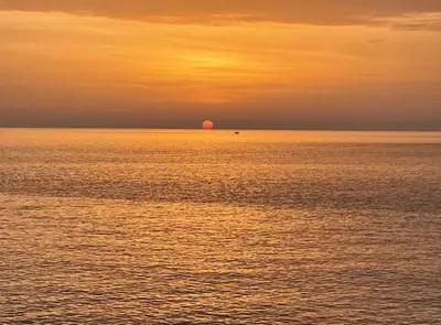 a sunset over the ocean with the sun in the distance at Apartments Dana Seaview in Bar