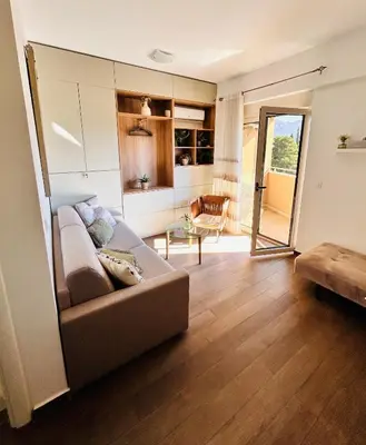 a living room with a couch and a table at Boljevic Apartments in Becici