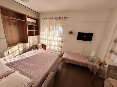 a bedroom with two beds and a tv in it at Boljevic Apartments in Becici