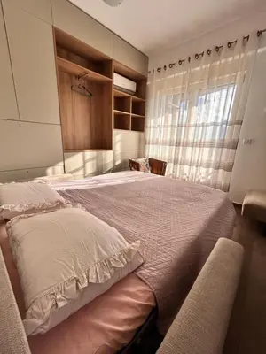 a bedroom with a large bed and a window at Boljevic Apartments in Becici
