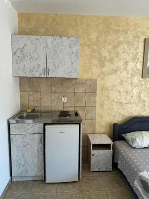 a small kitchen with a sink and a refrigerator at Apartmani Jelenaa in Budva