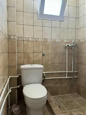 a bathroom with a toilet and a window at Apartmani Jelenaa in Budva