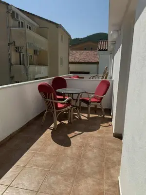 a patio with chairs and a table on a balcony at Apartmani Jelenaa in Budva