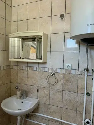 a bathroom with a sink and a mirror at Apartmani Jelenaa in Budva